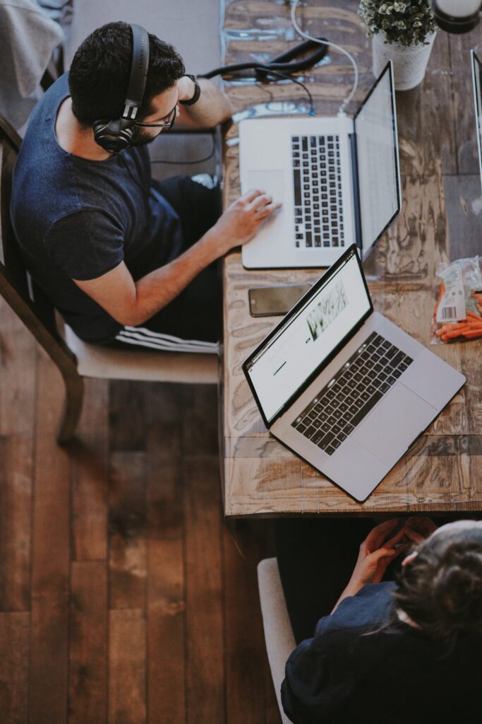 white male working on a laptop seen from above